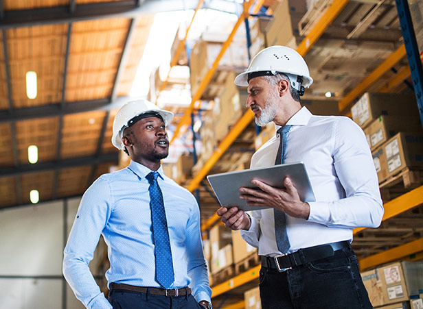 Two men talking with clipboard