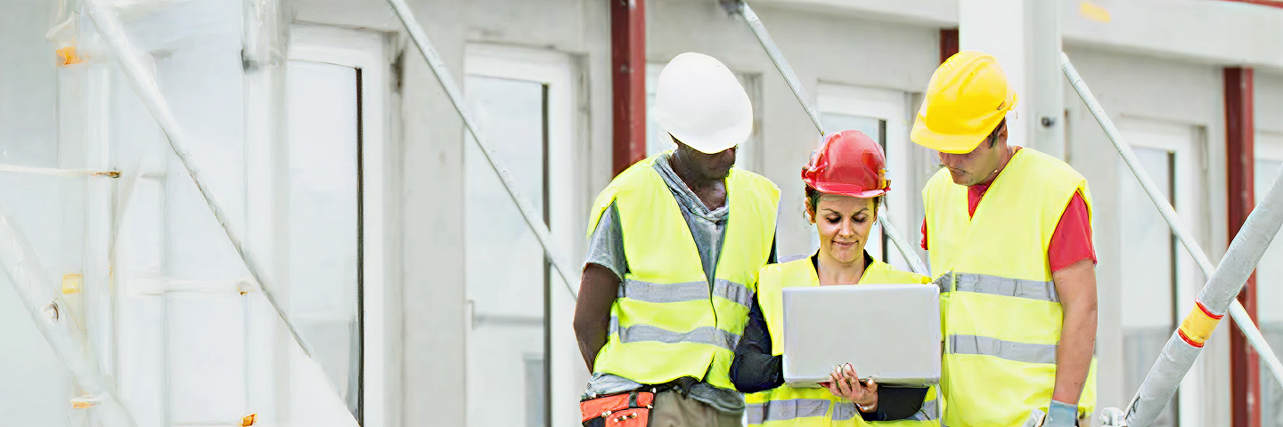 construction workers gathering with a laptop