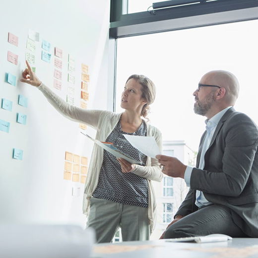 Office employees working at a white board