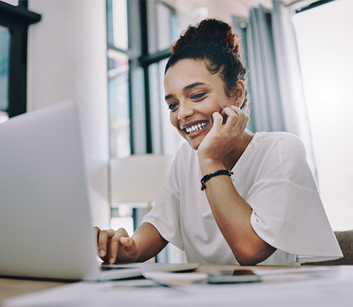 professional working remotely on a laptop in a modern open-plan office with contemporary furniture, ambient lighting, and collaborative workspace design